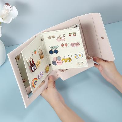 China PU Leather Jewelry Storage Book Shape Jewelry Storage With Mirror Custom Logo Small Travel Jewelry Organizer Box for sale