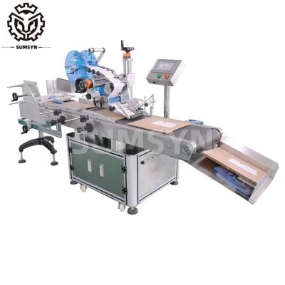 China Automatic plastic bag package labeling machine for carton clothing tag labeling PE bag and color box labeling for sale