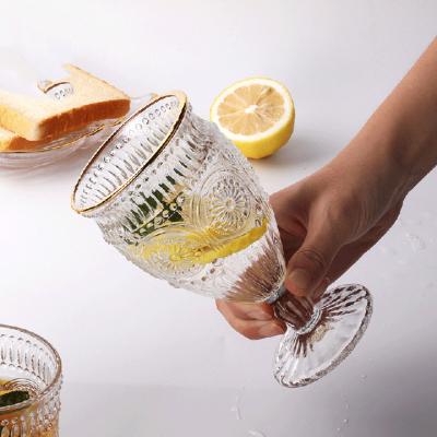 China Solid Color Wedding Gold Rim Clear Decoration Goblet Glassware Vintage Embossed Glass Wine Glasses for sale