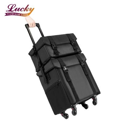 China Large Capacity 2 in1 Black Oxford Professional Makeup Train Case Trolley Makeup Rolling Bag For Makeup Artist for sale