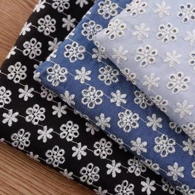 China Flower design cotton eyelet embroidery fabric breathable fashion jeans fabric denim floor manufacturer customized for women dress for sale