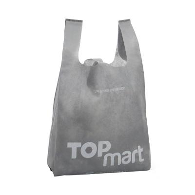 China Heat Seal Supermarket T-shirt Handled Non Woven Shopping Bag With Customized Logo for sale