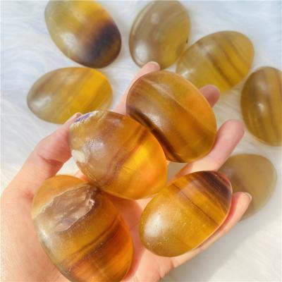 China DONGHAI Wholesale Price Hot Sale Natural Fluorite Yellow Crystal Palm Stone Healing For Meditation for sale