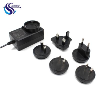 China UniversalÂ   Wholesale 12v 2a 24w Interchangeable Power Supply Wall Adapter 24v 1a Plug AC Change Adapter With Eu Us UK Au Plugs for sale