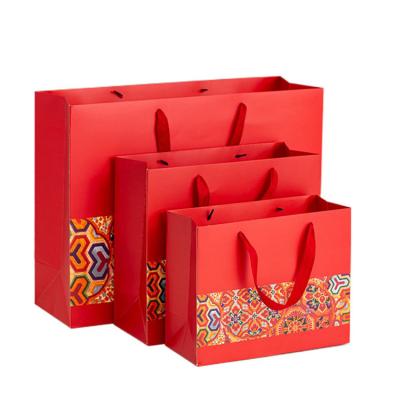 China Wholesale Exquisite Cheap Custom Design Luxury Shopping Red Paper Bags With Handles for sale