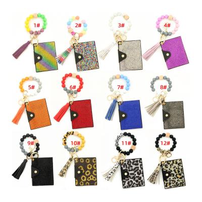 China 2022 Keychain Anti-theft PU Leather Wristband Card Holder Keychain Tassel Bracelet Tassel Wristband Card Holder Wooden Key Chain Wallet for Women for sale