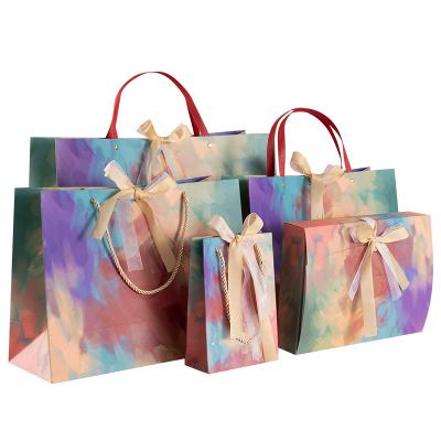 China Wholesale Colorful Recyclable Printied ART Paper Bag Gift Packaging Bag Shopping Bag With Ribbon for sale