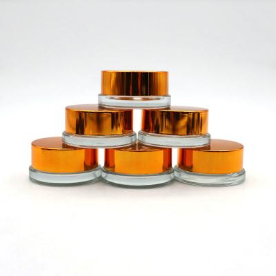 China Eco-freindly OEM 7ml clear round cbd wax oil concentrate glass jar with gold lid for sale