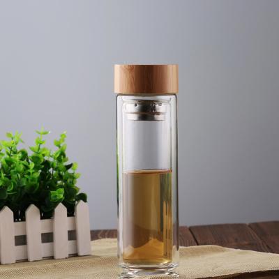 China Hand Made Beverage High Borosilicate Glass Tea Bottle With Wooden Lid Hot Selling for sale