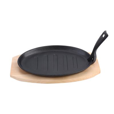 China Sustainable Sizzling Tray With Cast Iron Non Stick Steamy Day Wooden Base Pan Dish Mold for sale