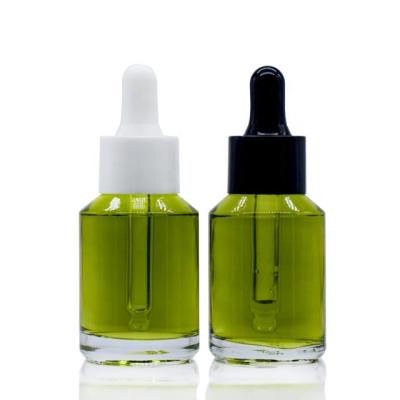 China Oblique shoulder transparent green glass bottle 30ml green dropper bottle for sale