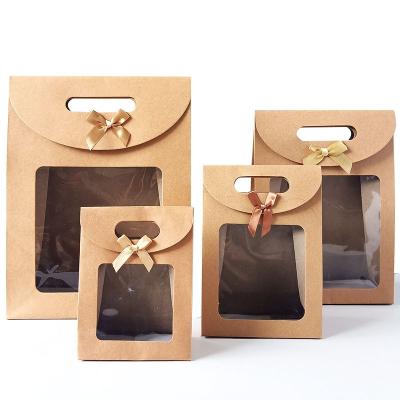 China Recycled Materials Stylish Customized Packaging Bags Custom Logo Blank Kraft Paper Gift Bags With Handles for sale