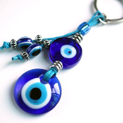 China Newest Fashion Lilangda Daily Life Hand Glass Eyes Turkish Evil Eyes Shape Blue Keychain Charms Tassel Key Chain for sale