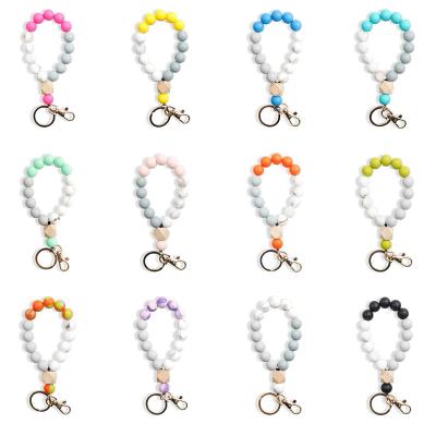 China Fanshion Lilangda Women's Keychains Monogram Disc Key Chain Ring Holder Silicone Bead Tassel Wooden Empty Bracelet Bangle for sale