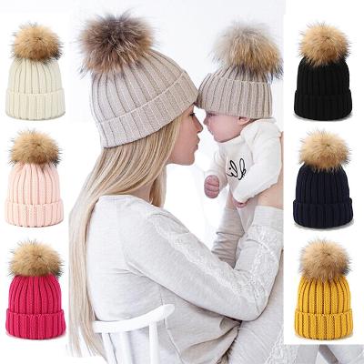 China COMMON Fur Pom Pom Hats Knit Beanie Hat with Finn Raccoon Fur Pompoms Winter Woven Fur Hats for sale