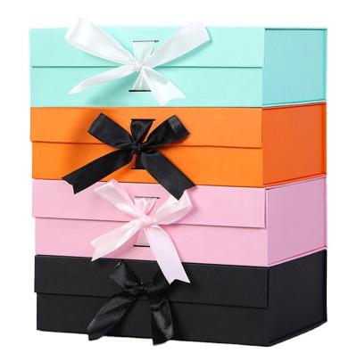 China Handmade wholesale small orange gold gift boxes with ribbon A4 fixed size white magnetic folding grosgrain giff box with ribbon for sale