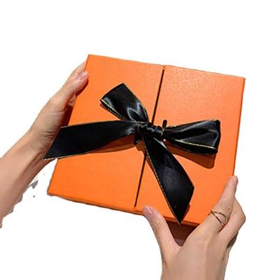 China Handmade Makeup Packaging Box Customized Double Opened With Silk Ribbon Orange Textured Luxury Gift Box Packaging for sale