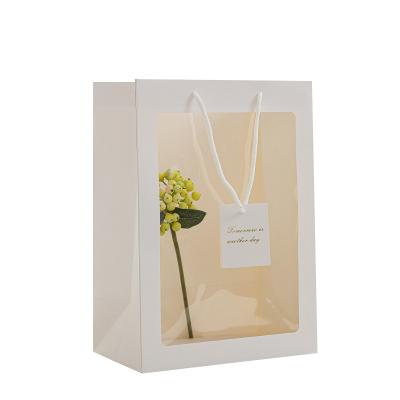 China Recycled Materials Wholesale Creative Transparent Flower Bouquet Gift Wrapping Window PVC Packaging Paper Bag With Ribbon Handle for sale