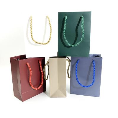 China Recycled Materials Customized Branded Logo Luxury Black Paper Apparel Packaging Gift Shopping Bag Paper Bag for sale