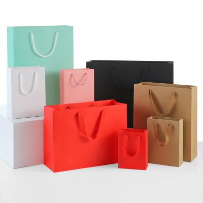 China Wholesale Recycled Hot Selling Materials Custom Bright Color Clothing Small Cool Gift Packaging Portable Kraft Paper Shopping Paper Bags for sale