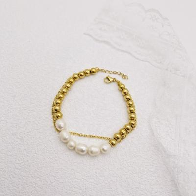 China FASHIONABLE Elegant Golden Round Ball Beads Adjustable Freshwater Pearl Elastic Rope Chain Bracelet For Women for sale