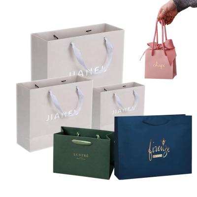 China Recyclable OEM Customized Logo Printed Small Retail Boutique Chupi Jewelry Luxury Cardboard Art Gift Shopping Paper Bag With Ribbon Handles for sale