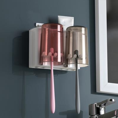 China Multifunction Eco-friendly Punch-free Wall Mounted Toothbrush Holder Set With Round Brushing Cup For Bathroom for sale