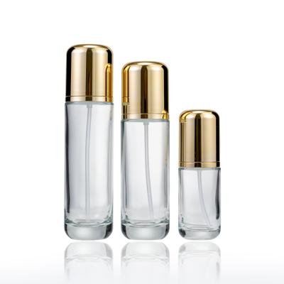 China Eco-friendly Refillable Refillable Clear Skin Care Packaging 40ml 100ml 120ml Serum Bottles Glass Lotion Bottle With Gold Pump for sale