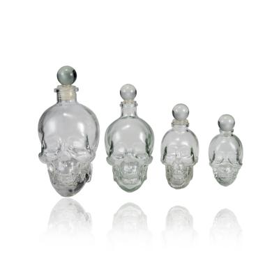 China 100ml 180ml 380ml 750ml Eco-friendly Recyclable Custom Skull Shape Clear Glass Liquor Bottles Vodka Brandy Whiskey Bottle With Cork for sale