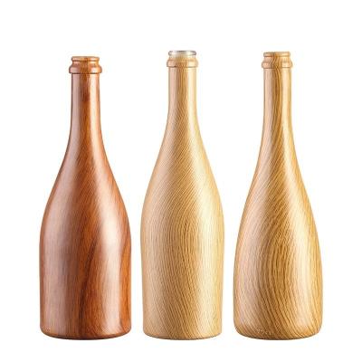 China Tamaño personalizado aceptado 750ml/350ml Botella de vidrio de patrón de madera para cerveza agua champán en venta