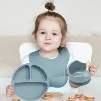 China Minimalist Food Grade Feeding Set Include Bib Dish Silicone Baby Bowl And Wooden Handle Spoon Kid Baby Dinner Set Silicon For Baby Eating Set for sale