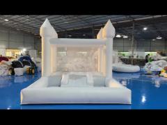 white bounce house with ball pit and slide