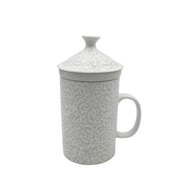 China Sustainable Sublimation White Ceramic Emboss Mug With Lid And Filter Tea Cup for sale