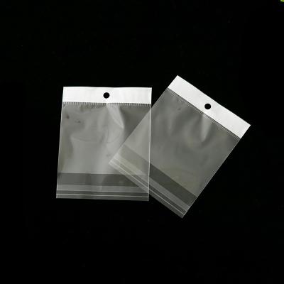 China Disposable opp cut hole white hanging bag accessories self-adhesive transparent self-adhesive plastic bag for sale