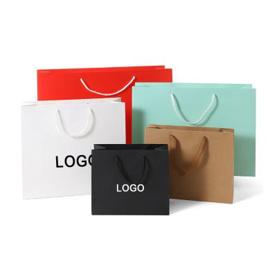 China Recycled Materials White Paper 250g Cardboard Paper Bag Custom Clothing Bags With Black Logo Paper Straps for sale