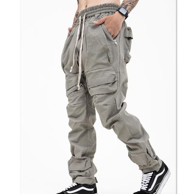 China OEM Manufacturers Anti-Wrinkle Cargo Pocket Multi Custom Men's Elastic Lane Solid Color Drawstring Waist Logo Elastic Utility Pants Tactical Pants for sale