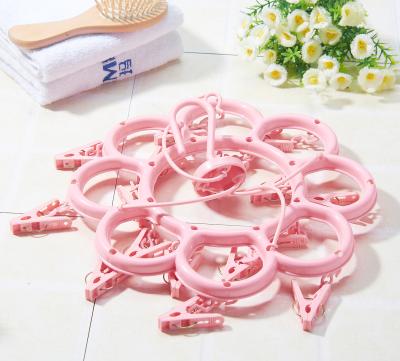 China Traditional Cheapest Plastic Flower Shape Clothes Hanger Anti-wind Clothes Hanger Laundry Rack With 16 Piece Pegs for sale