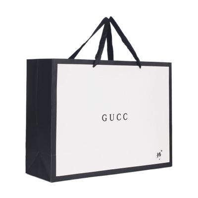 China Durable Custom Paper Gift Bags Garment Bags White Card Handbags for sale