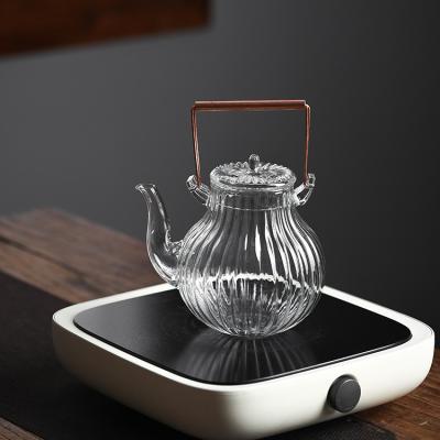 China 850ML Bososilicate Galss Viable Heat Resistant Coil Filter Glass Teapot With Cooper Wooden Handle for sale