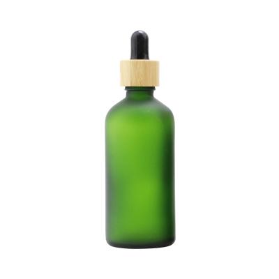 China 10ml/30ml/50ml Frost Green Essential Oil Cosmetic Eco Friendly Glass Bottle With Bamboo Lid for sale