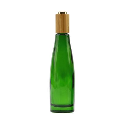 China High Quality Green Cosmetic Bottle Glass Lotion Bottle With Bamboo Lid Sprayer For Cosmetic Skin Care for sale