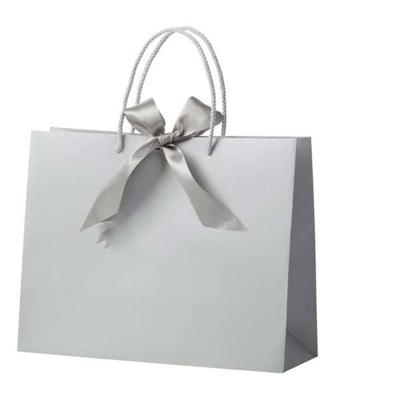 China Recycled Materials Luxury Fancy Paper Kraft Paper Custom Shopping Bag With Ribbon Handle for sale