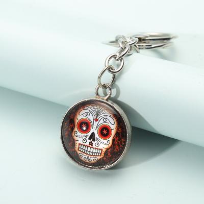 China New Promotion Souvenir Gift Fashion Cartoon Metal Key Rings Glass Ball Luminous Pendant Skulls Key Chain for sale