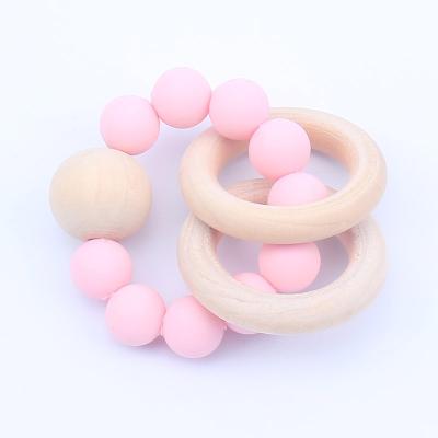 China Wooden Teeth Ring Baby Teeth Toy Infants Teether Toy Amazon Hot Sale Sensory Toy Baby Teether BPA Silicone Soft Round Balls Free Wristband for sale