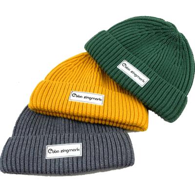 China Trendy JOINT Fashion Knit Beanie Winter Beanie Hat With Rubber Patch Ribbed Beanie for sale