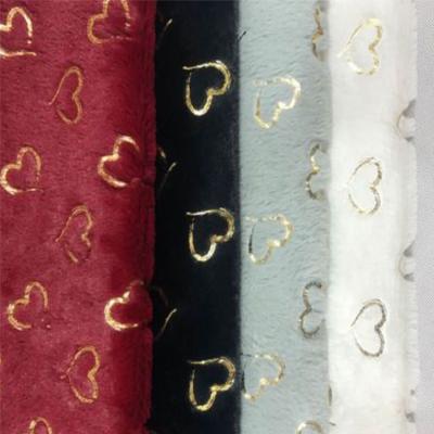 China Warm Embossed 100% Flannel Velvet Fabric Compound Anti Pill Golden Polyester for sale