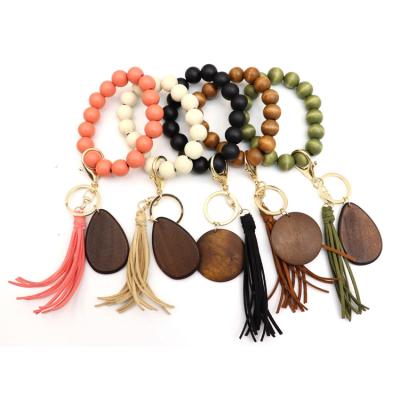 China Wholesale Korean Flexible Hip Hop Tassel Key Chain Colorful Beaded Bracelet Wood Beads Key Chain for sale