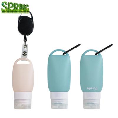 China Custom Portable Silicone Pocket Key Chain Hanging Empty Hand Sanitizer Bottle with Door Opener Key Chain Badge Reel Holder Clip for sale