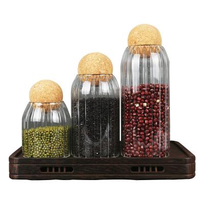 China Heatable Glass Jars For Storage Food Storage Jars With Wooden Lid Cork Ball Stopper Handmade Borosilicate Canister Glass Jar for sale