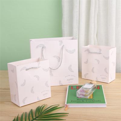 China Handmade Gift Bag White Feather Square Hand Carry Bag Portable Clothing Paper Bag Custom for sale